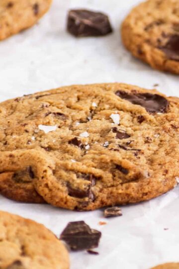 veagn chocolate chip cookie with chocolate pools and flaky sea salt.