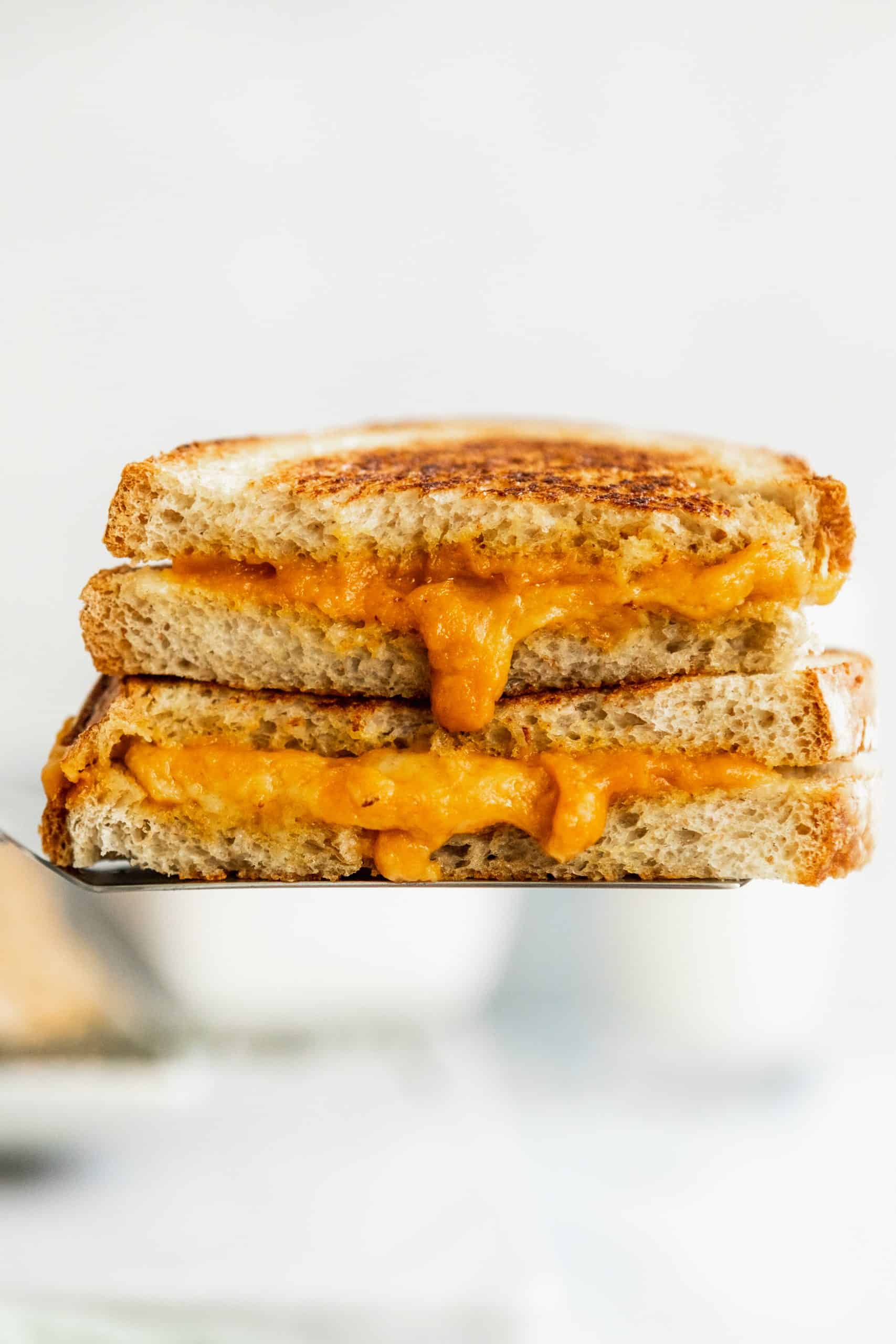 Vegan Grilled Cheese stacked on a plate.