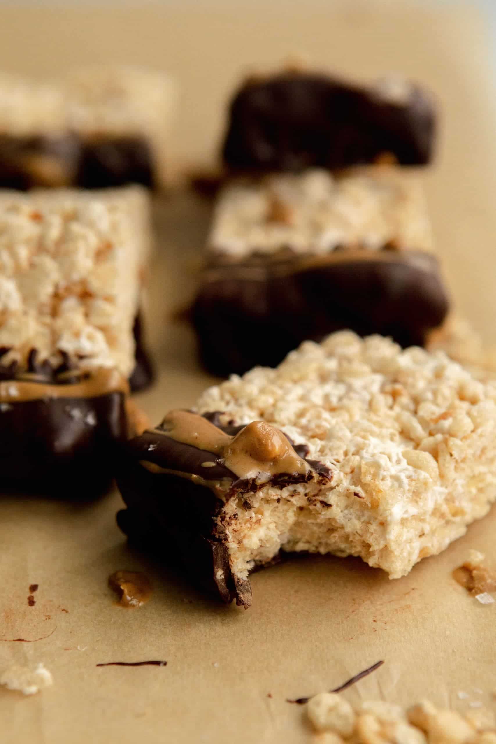 Vegan Rice Krispie Treat with Chocolate and Peanut Butter with a bite taken out of it.