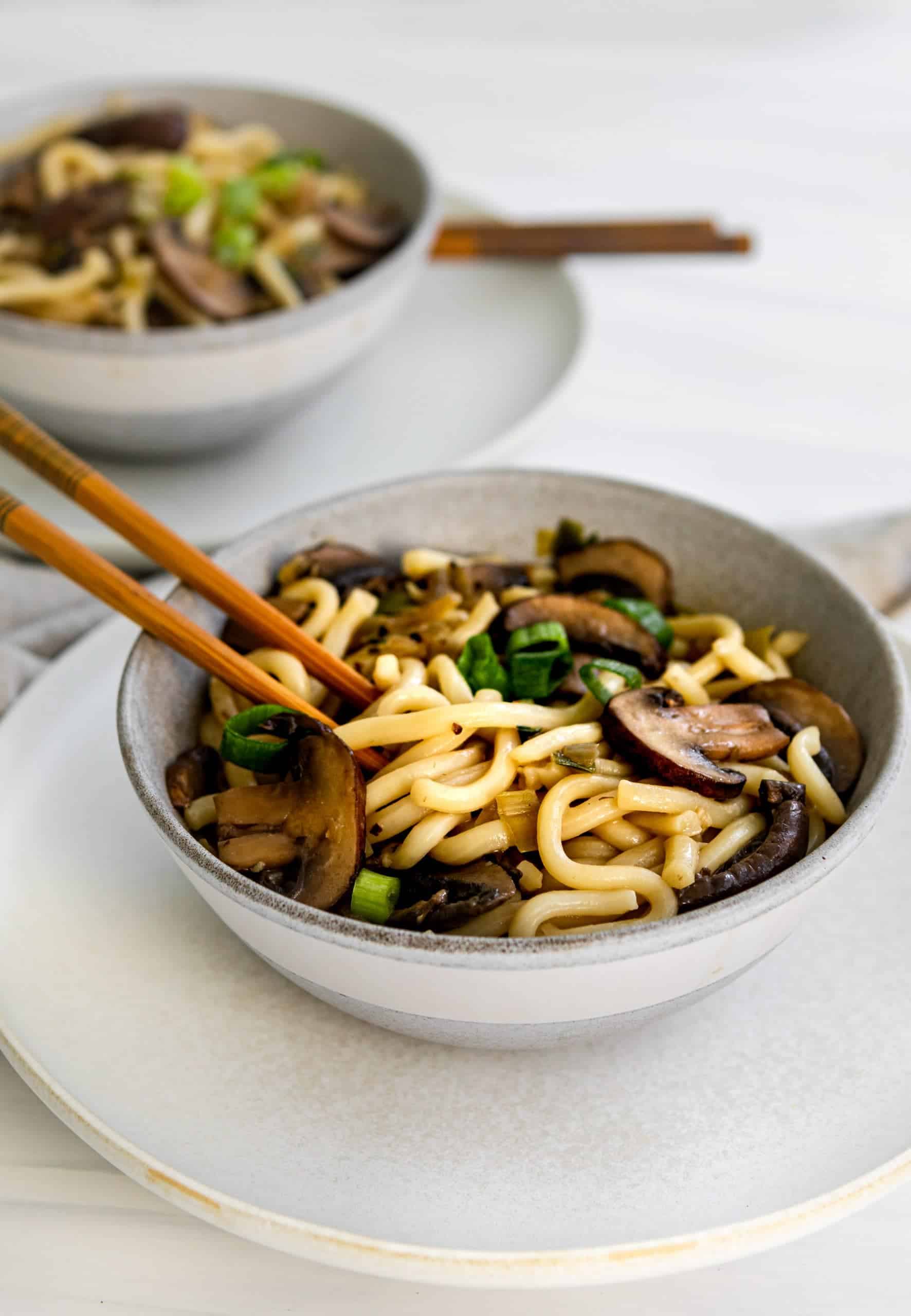 noodles with mushrooms, garnished with fresh green onions