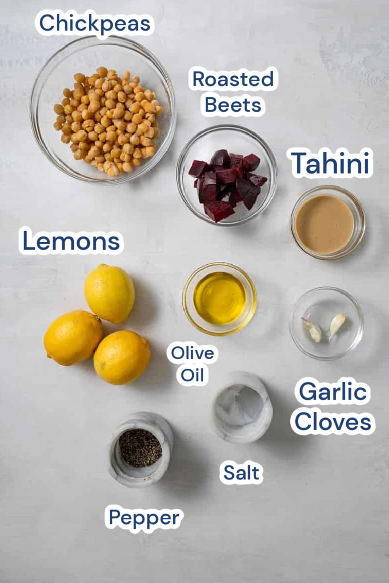 ingredients for lemon beet hummus: chickpeas, roasted beet, tahini, lemons, olive oil, garlic, salt, pepper.