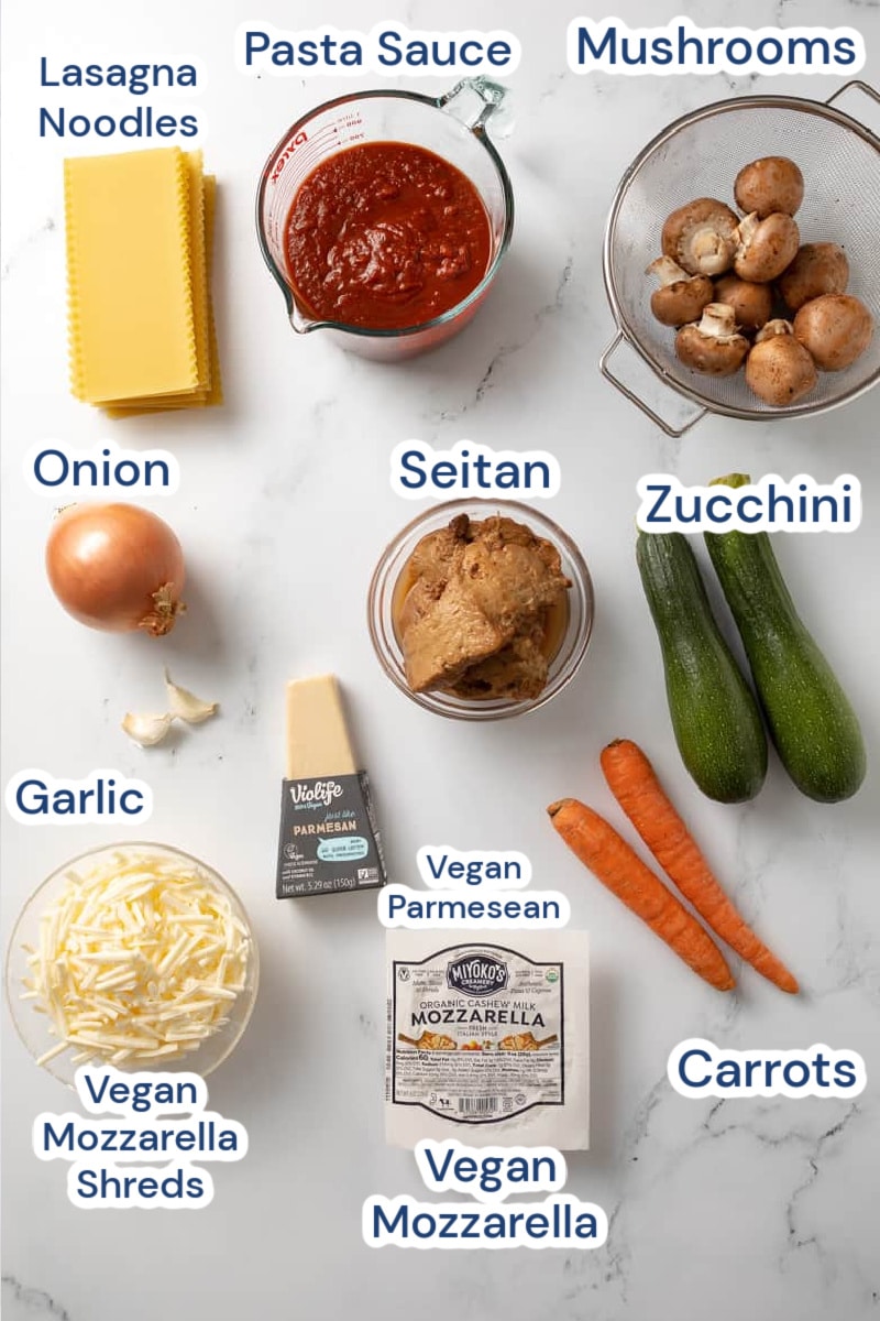 ingredients for vegan lasagna: mushrooms, pasta sauce, lasagna noodles, seitan, zucchini, onion, garlic, vegan parmesan, carrot, vegan mozzarella shreds, mozzarella vegan.