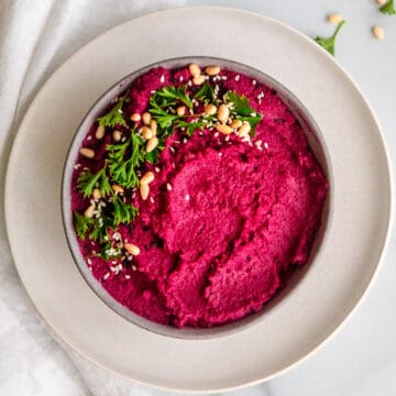 bright pink lemon beet hummus with parsley, pine nuts and sesame seeds.