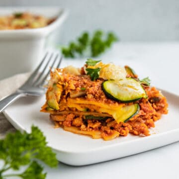 vegan lasagna layers with veggies and seitan bolognese.