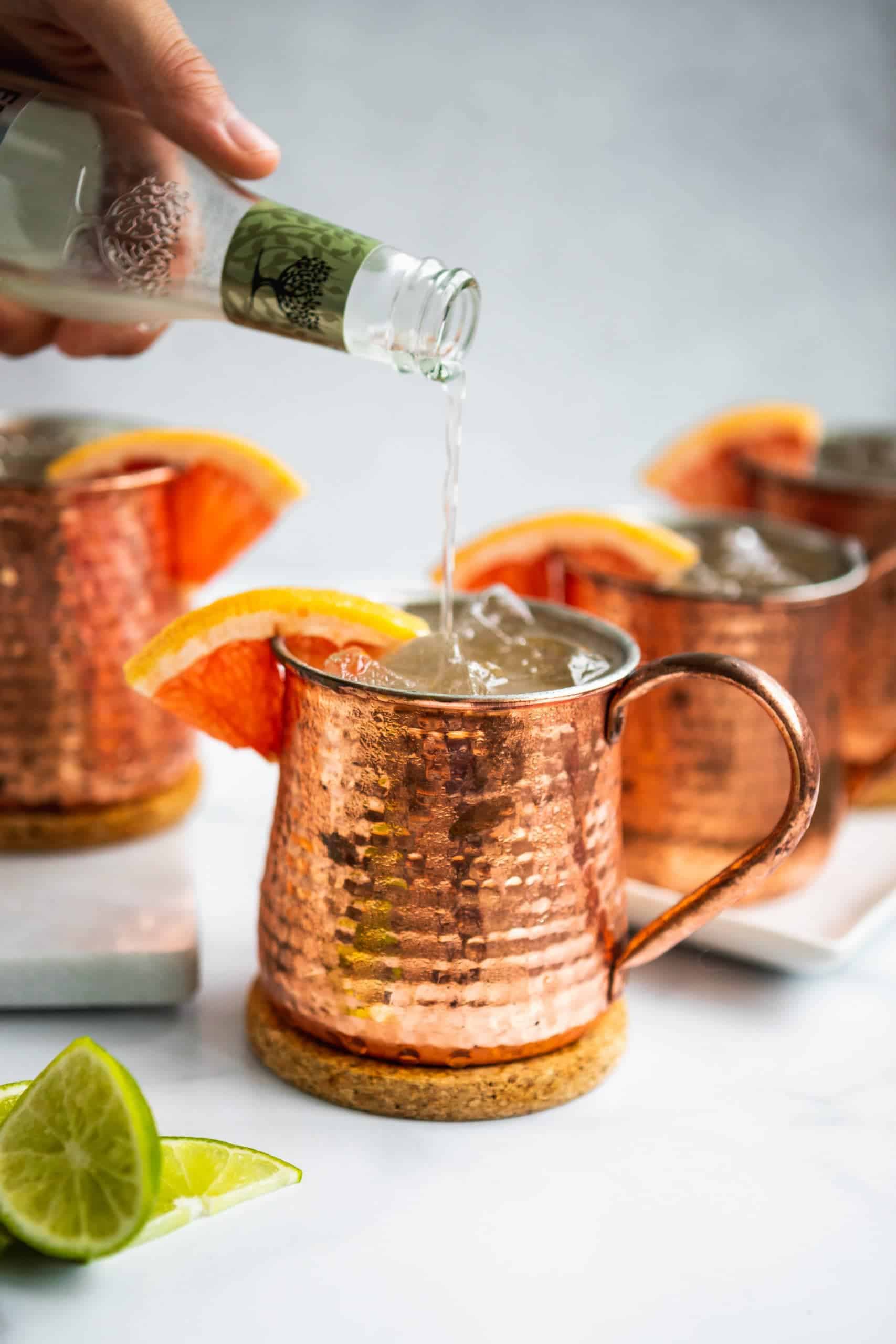 ginger beer pouring into copper mug