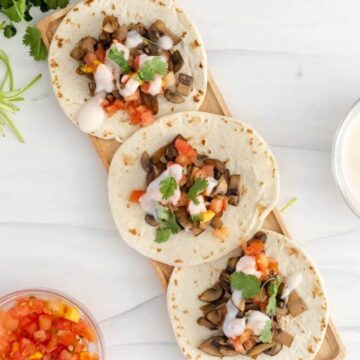 Vegan Mushroom Tacos on a plate with toppings around