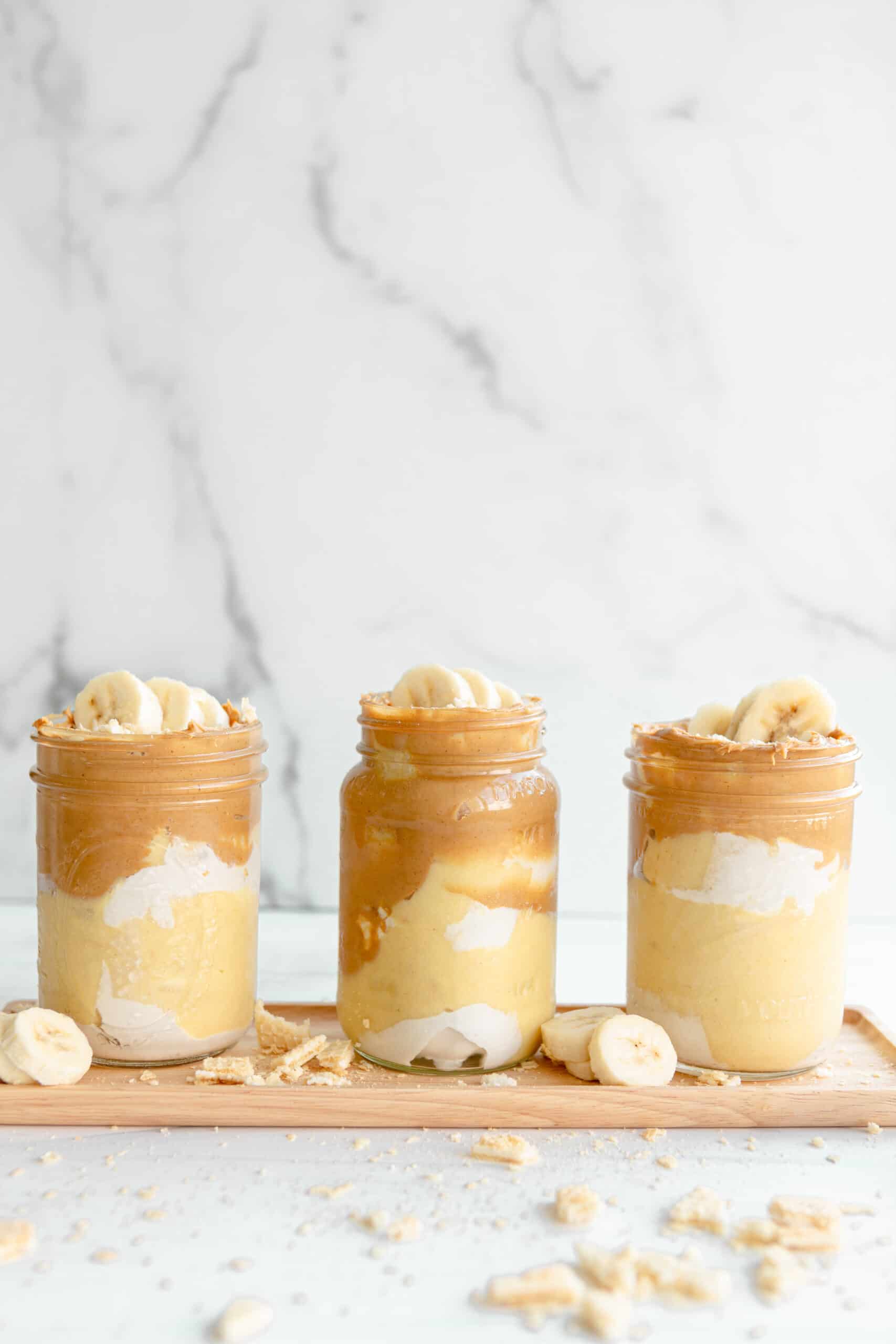 3 Vegan Peanut Butter Banana Pudding jars..ingredients in layers.