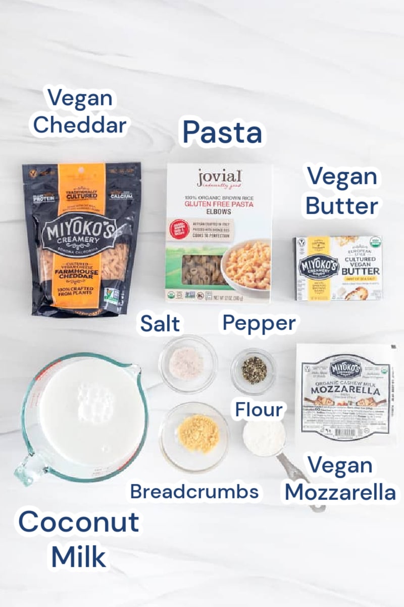 ingredients for classic baked vegan mac and cheese, vegan cheddar, vegan butter, pasta, salt, coconut milk, pepper, vegan mozzarella, breadcrumbs vegan, flour.