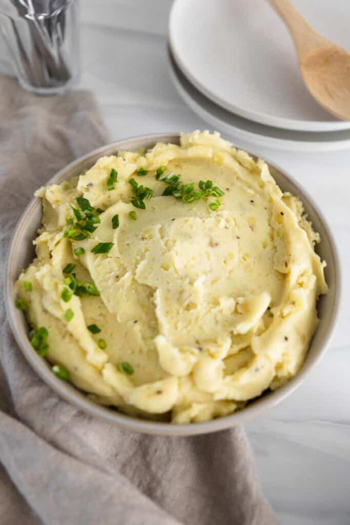 Bowl of plant based mashed potatoes with chives 