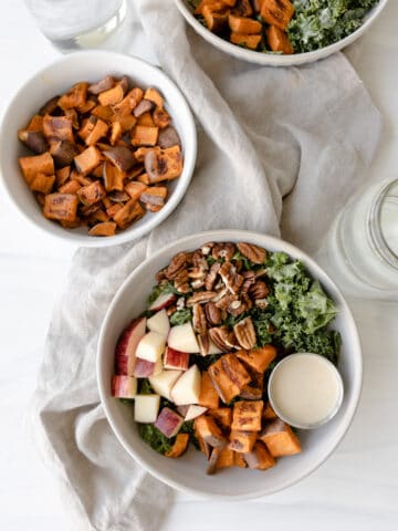 Vegan Sweet Potato Bowl overhead with roasted sweet potatoes, pecans, apples, kale and lemon tahini dressing