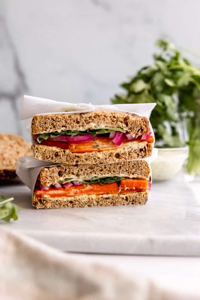 Roasted carrot sandwich with pickled red onions and greens stacked