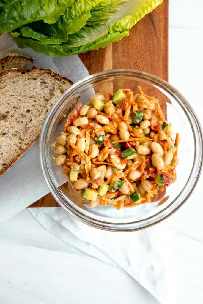 chickpea salad in a glass bowl with bread slices