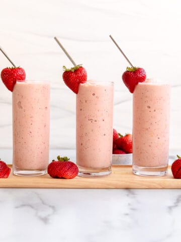 Strawberry Mango SmoothieS WITH A STRAWBERRY AND STRAW