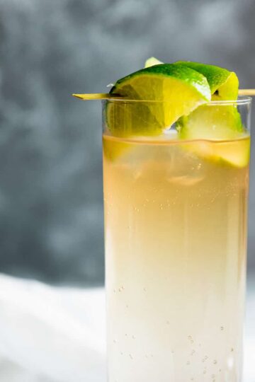 dark and stormy in a collins glass with lime garnish.