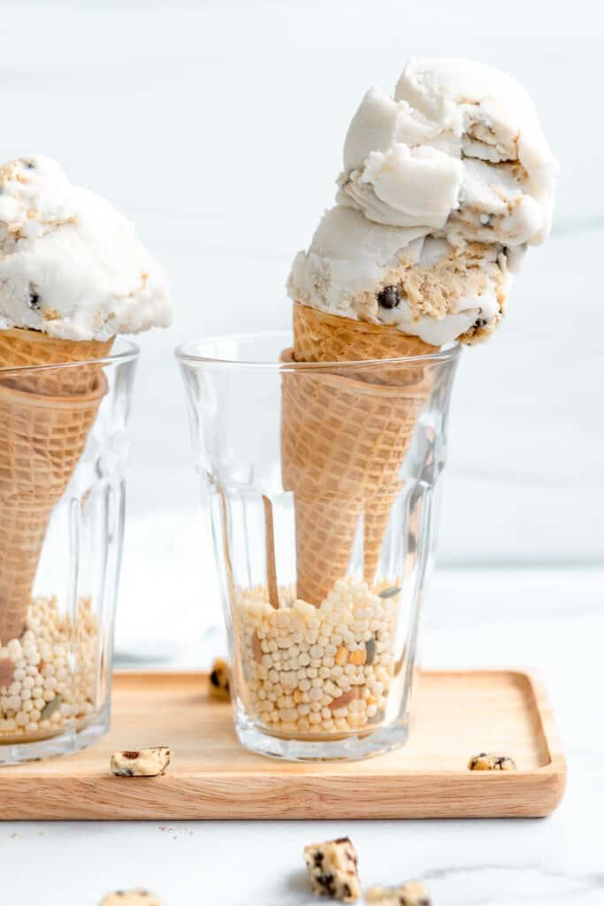two scoops of vegan cookie dough ice cream on a sugar cone
