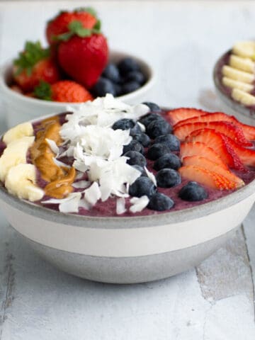 smoothie bowl with coconut flakes, berries, peanut butter and bananas