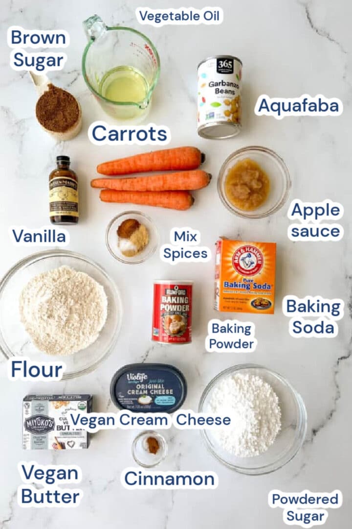 ingredients for vegan carrot cake loaf, carrots, aquafaba, vegetable oil, brown sugar, vanilla, mix spices, baking powder, baking soda, vegan cream cheese, vegan butter, powdered sugar, cinnamon.