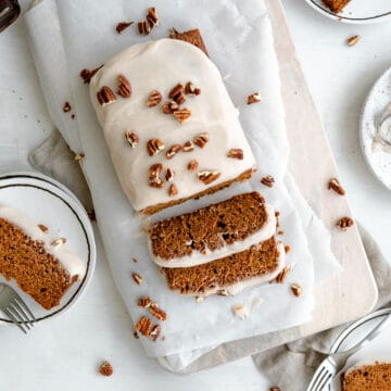 carrot cake loaf slices, topped with cream cheese icing and chopped pecans.