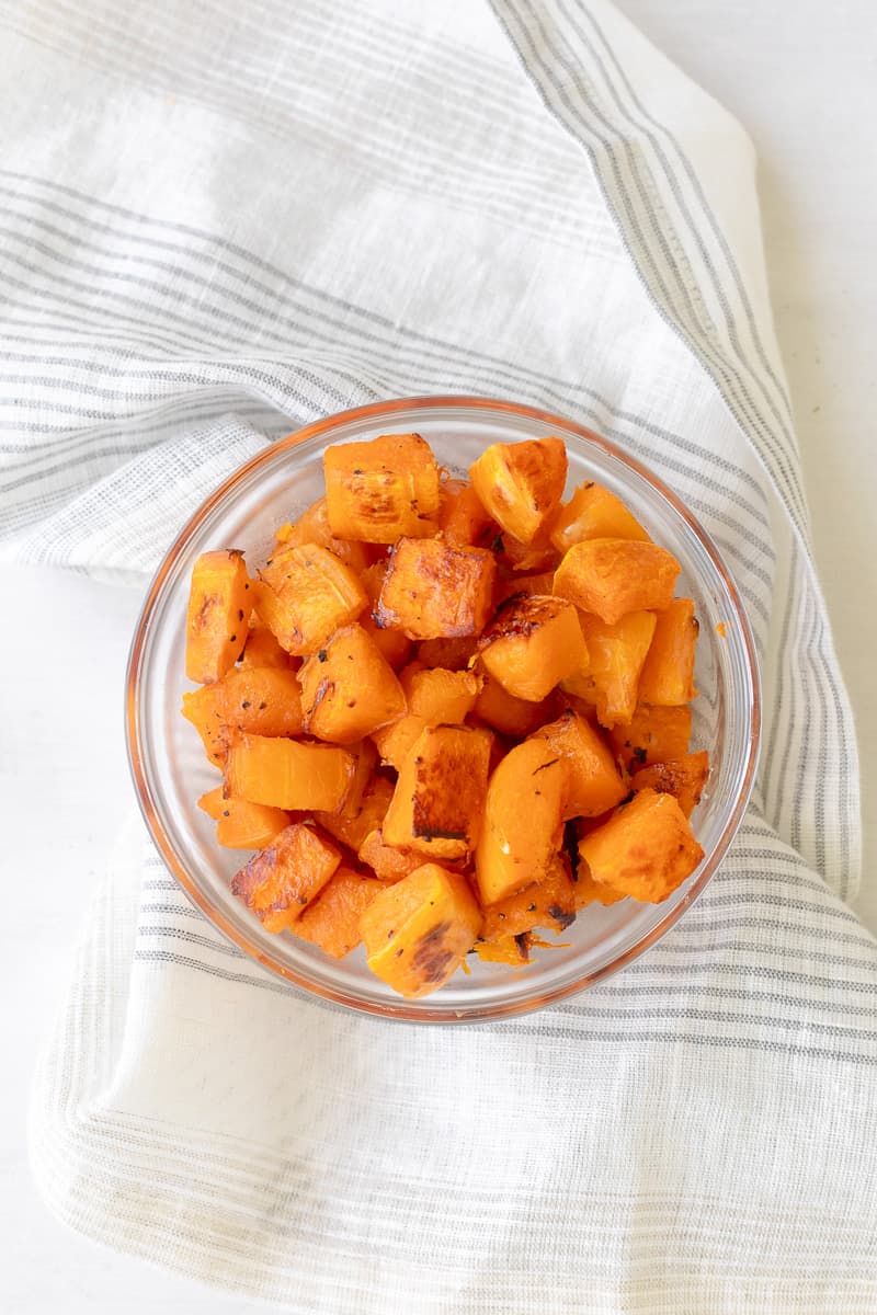 roasted butternut squash with some light brown bits in a bowl