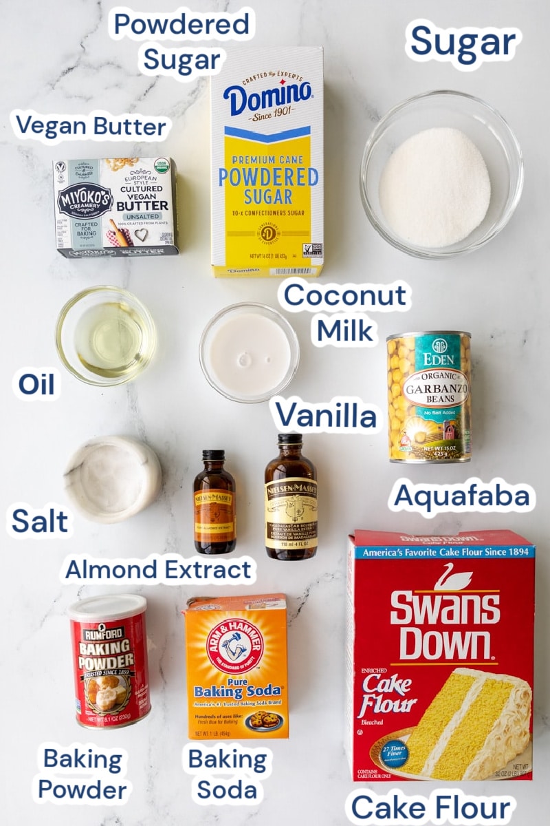 Ingredients for soft vegan sugar cookies, powdered sugar, vegan butter, granulated sugar, vegetable oil, coconut milk, aquafaba, salt, almond extract, vanilla, aquafaba, cake flour, baking soda, baking powder.