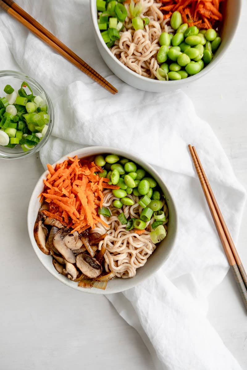 vegan ramen noodles with carrots, edamame, mushrooms, onions, and miso broth