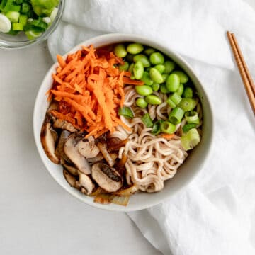 easy vegan ramen noodles with carrots, edamame, mushrooms, onions, and miso broth.