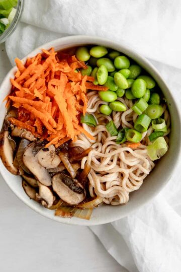 easy vegan ramen noodles with carrots, edamame, mushrooms, onions, and miso broth.