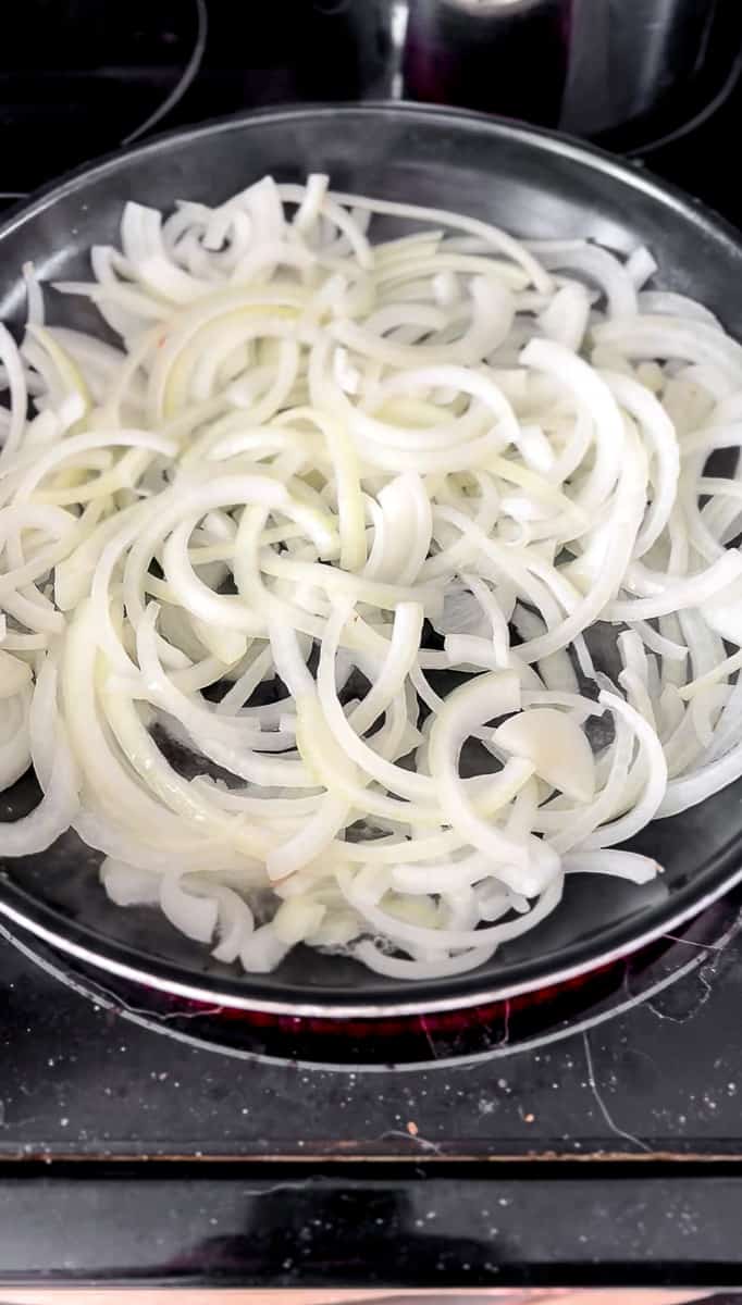 Raw onions in a frying pan