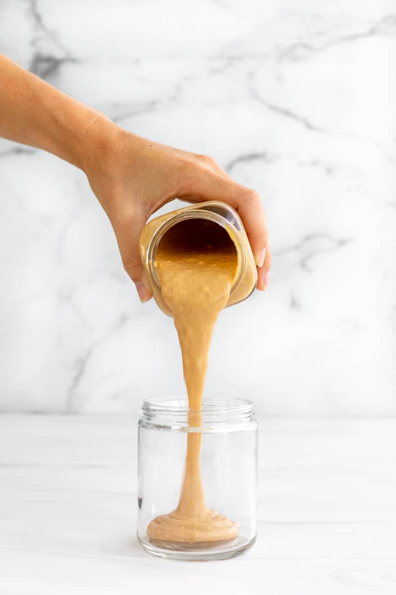 peanut butter sauce pouring into a jar