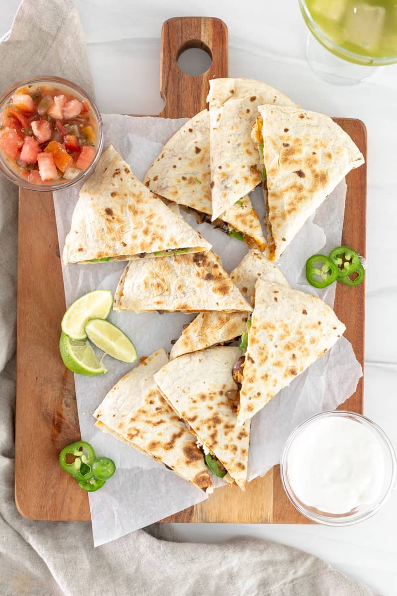 triangles of vegan quesadillas on a board