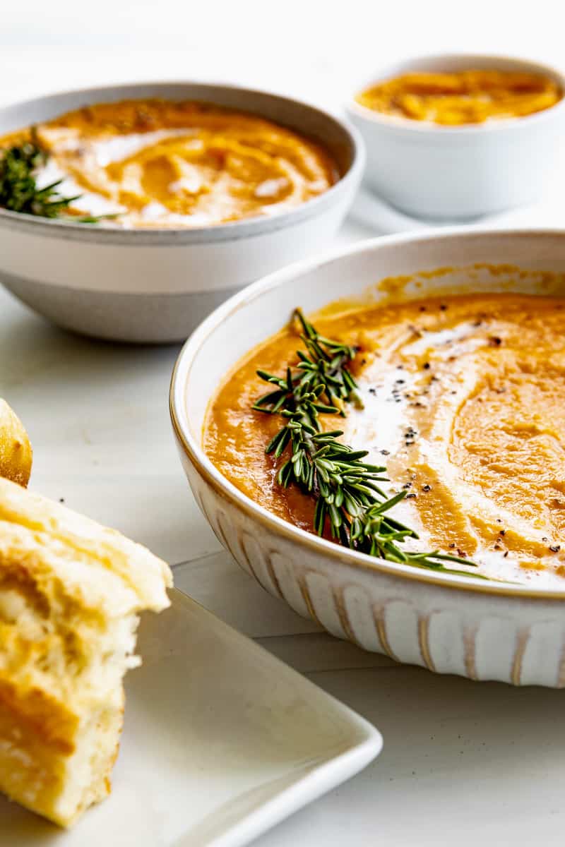 Creamy butternut squash bisque with a sprig of rosemary and drizzle of coconut milk. 
