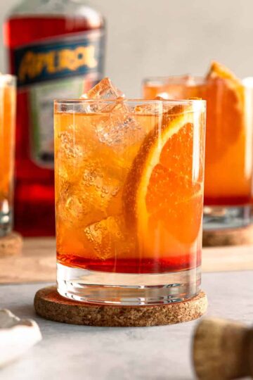 aperol cocktail with fresh orange slice and ice.