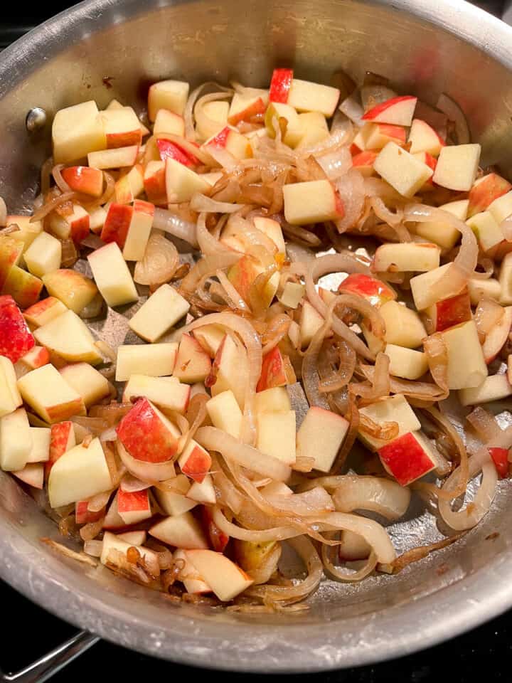 Diced apples in a pan with with sauteed onions