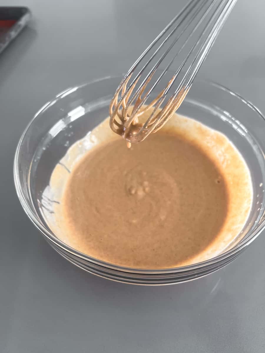 super smooth peanut sauce with a couple drops lingering on the surface