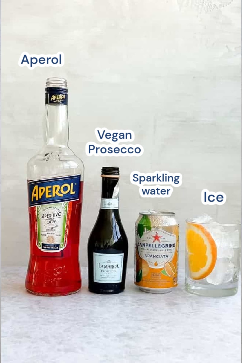 Aperol spritz ingredients: aperol, prosecco, sparkling water/juice, ice, orange slice.