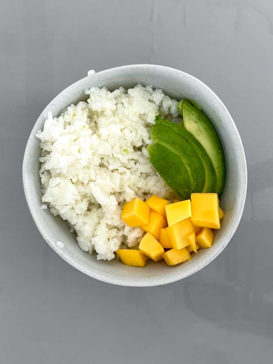 Coconut rice, avocado and cubed mango in a bowl
