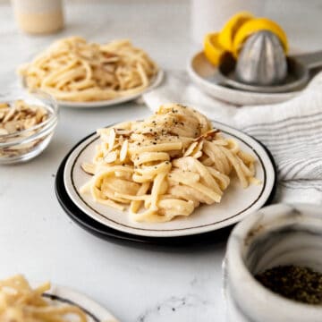 noodles with white bean pasta sauce with pepper flakes and toasted almonds