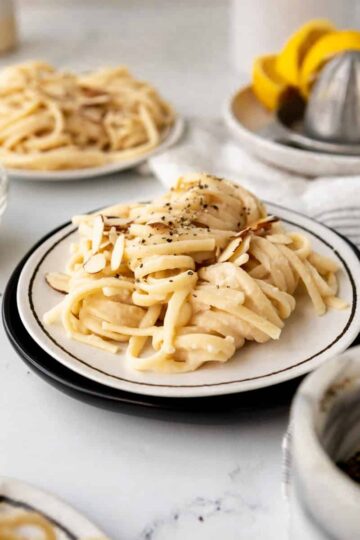 noodles with white bean pasta sauce with pepper flakes and toasted almonds.