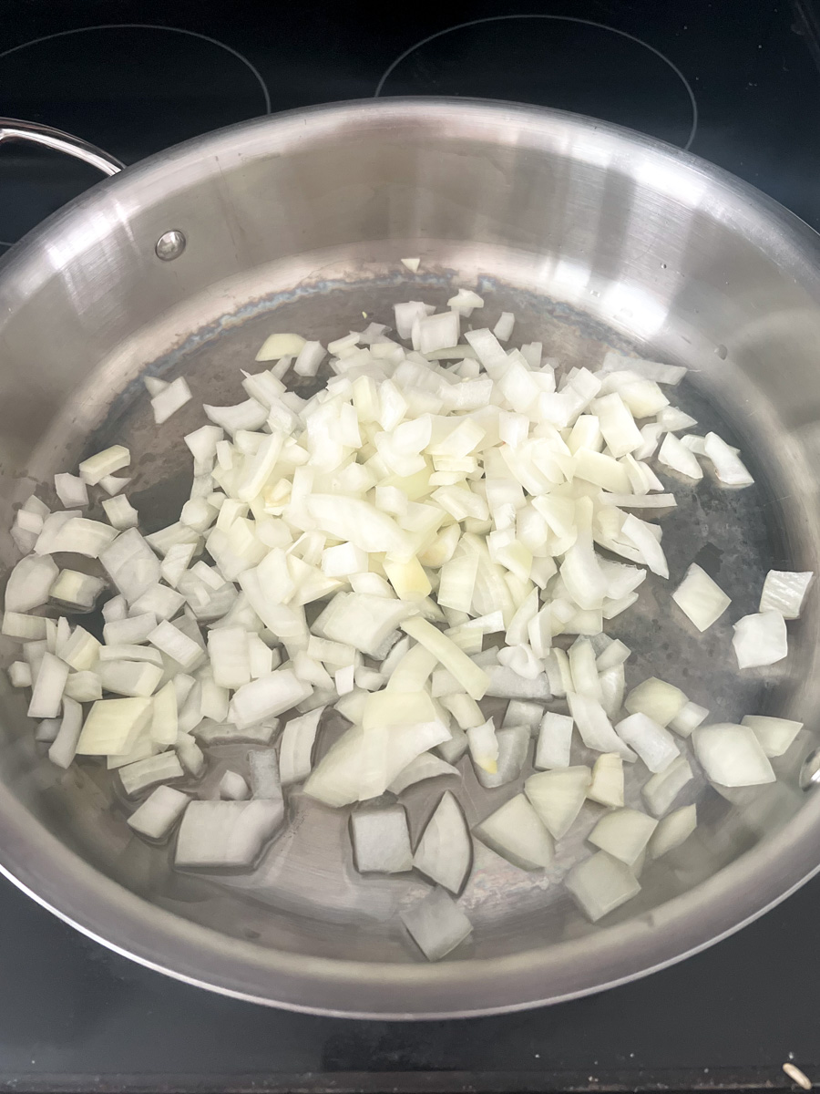 Raw diced onions in a frying pan