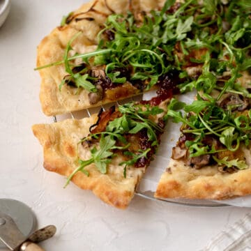 mushroom arugula pizza slice.