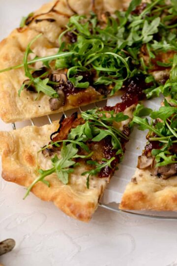 mushroom arugula pizza slice.