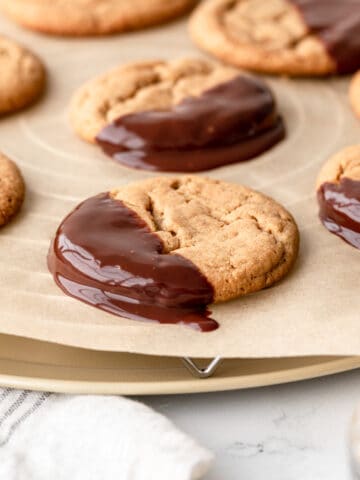 peanut butter cookie freshly dipped into chocolate ganache
