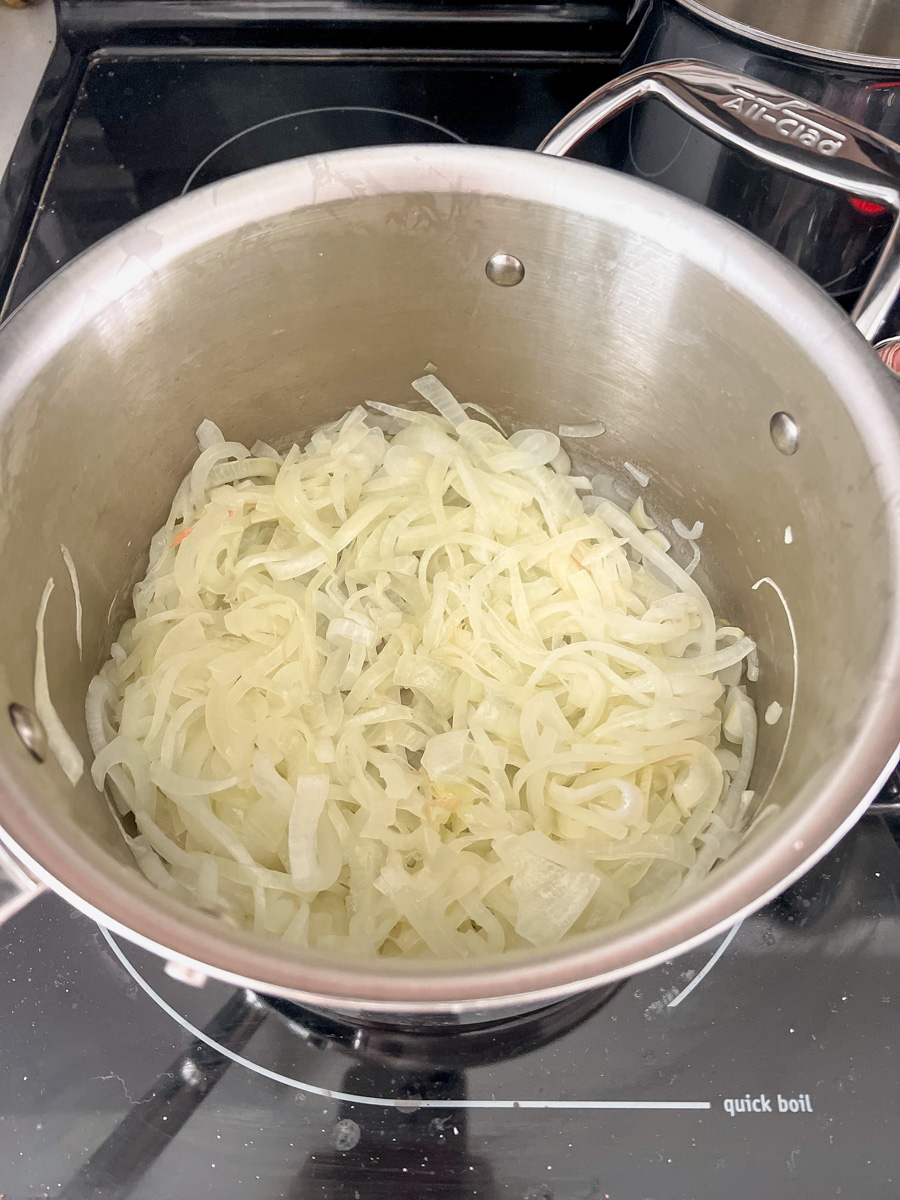 translucent onion slices in a medium saucepan - half the volume as raw onions