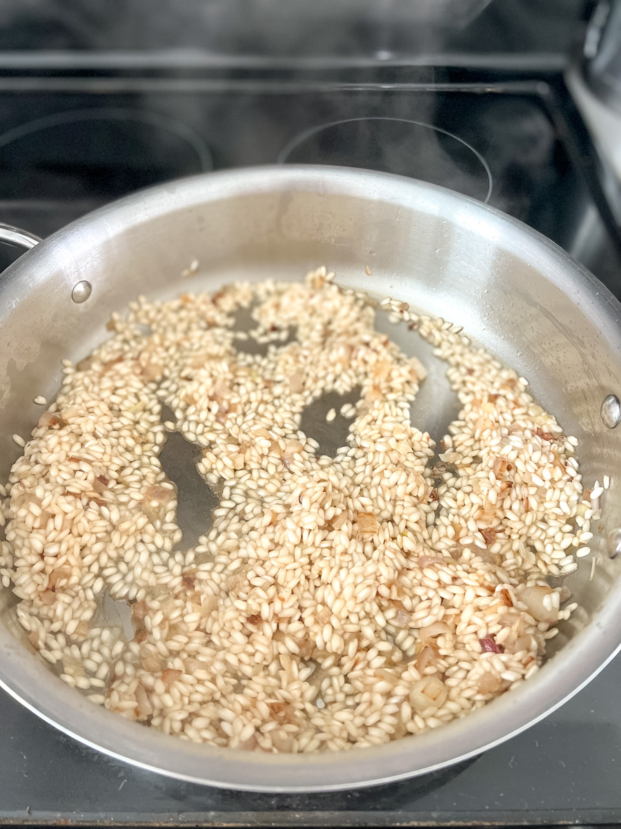 arborio rice that has absorbed some liquid in a pan 