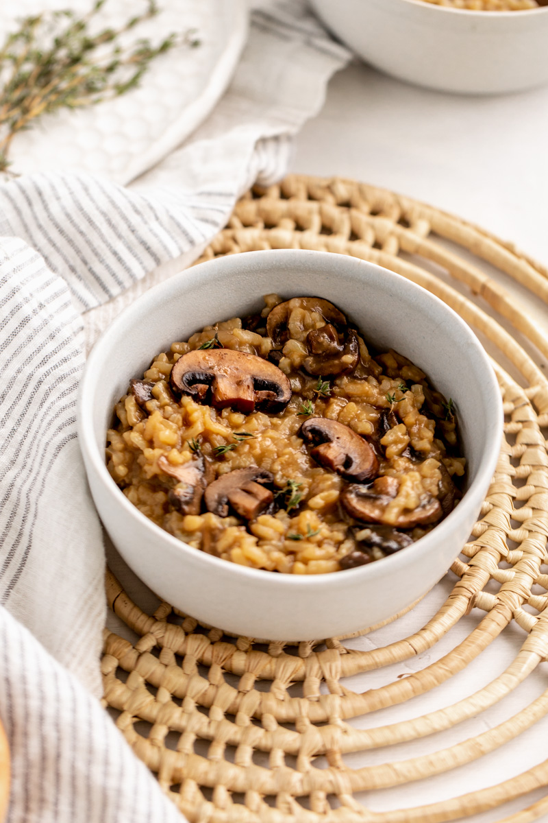 creamy risotto topped with sauteed mushrooms and thyme leaves