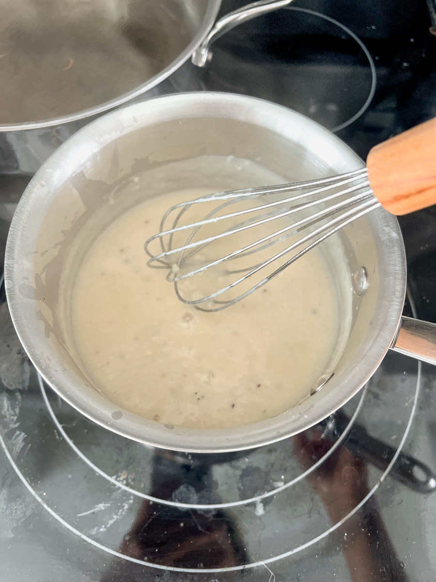 Thick white sauce in a saucepan