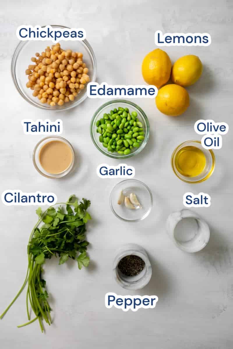 ingredients for edamame hummus: chickpeas, lemons, edamame,  tahini, garlic, olive oil, cilantro, salt,  pepper.