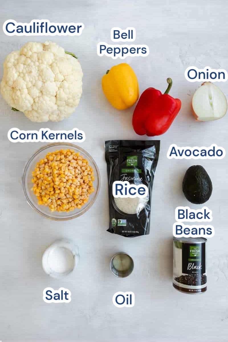 ingredients for vegan mexican rice burrito bowl: cauliflower, bell peppers, onion, avocado, corn kernels, rice, oil, black beans, salt.