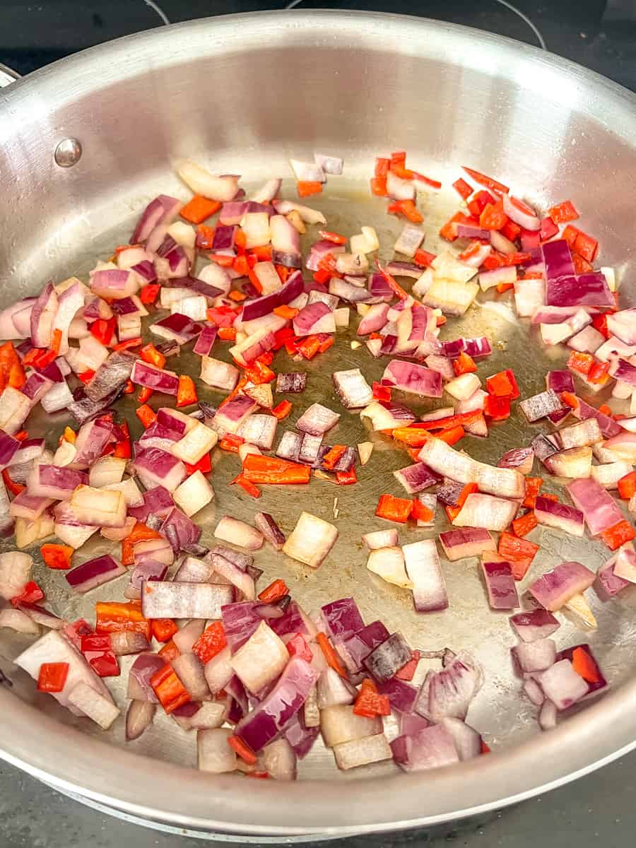 large pan with sauteed red onions and pepper
