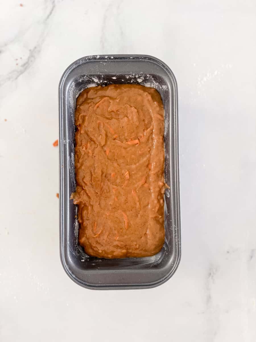 carrot cake batter in greased and floured loaf pan
